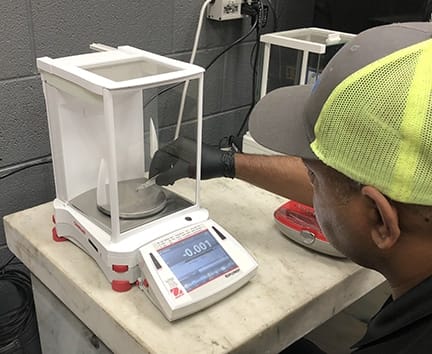 Michelli technician reviewing aging scale equipment condition to advise on replacement planning