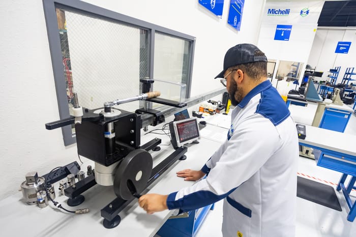 Michelli Weighing & Measurement technician performing on-site calibration of industrial weighing equipment