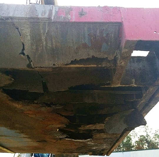 Rot on the right side of a truck scale caused by failure to clean debris