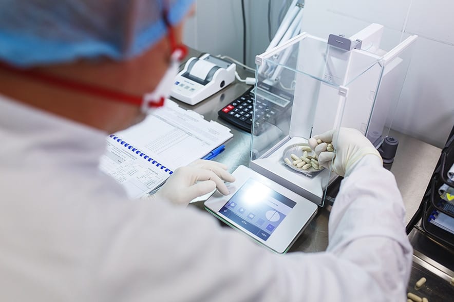 Precision analytical balance in a laboratory environment used for high-accuracy sample weighing and formulation work