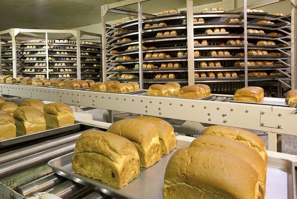 In-motion checkweigher on a food production line used for automated package inspection and weight verification