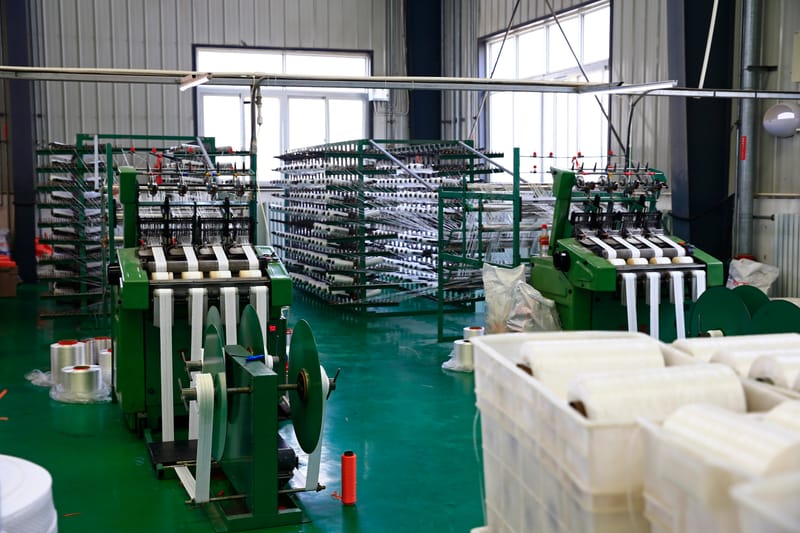 Textile machinery on a factory floor representing generic hardware installations without integrated local support