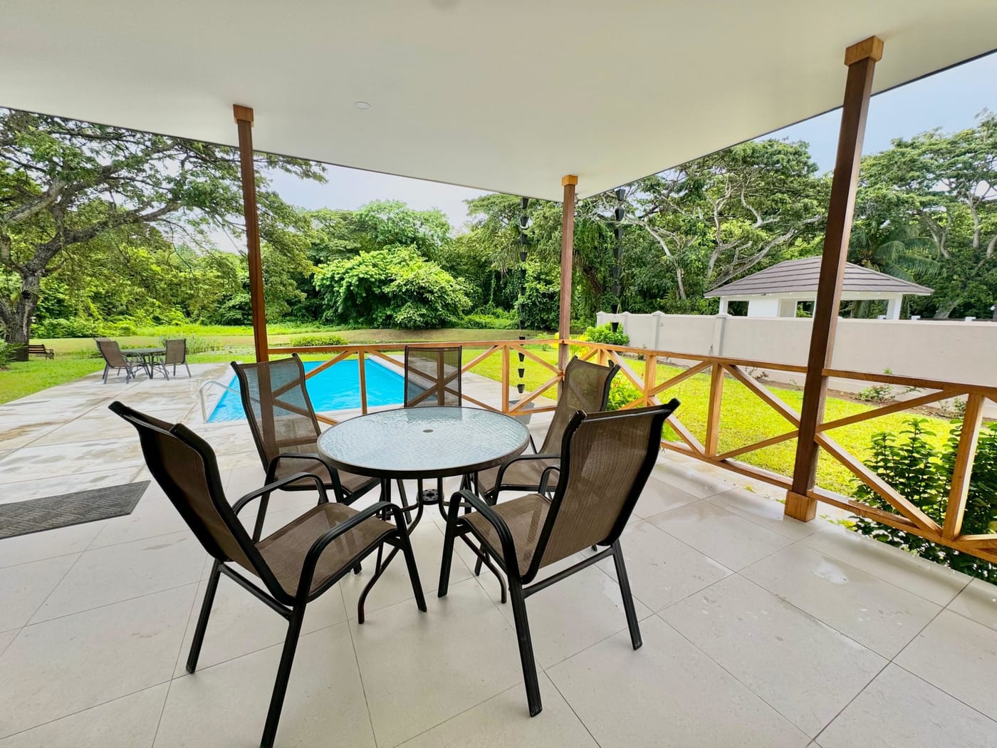 Villa 50 Samaan Grove covered porch overlooking the infinity pool and lily pond, Tobago