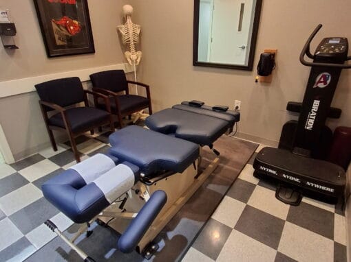 Clinic room with treatment tables and exercise equipment