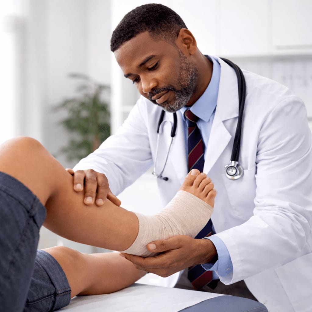 Doctor examining a patient's bandaged knee