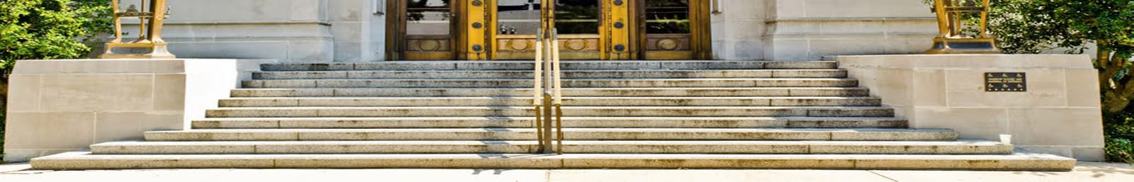 Front steps and brass doors of a stone government building